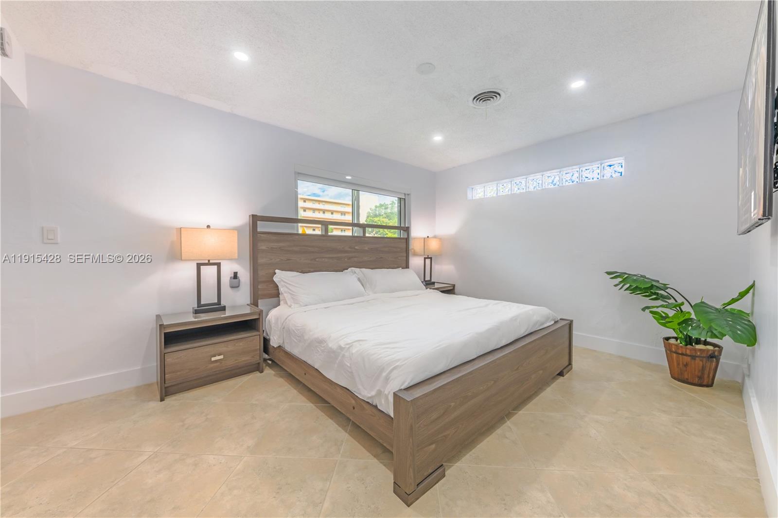 314 Southeast 3rd Street Dania Beach, FL 33004 - Photo 22 of 26 a bedroom with a bed and a potted plant