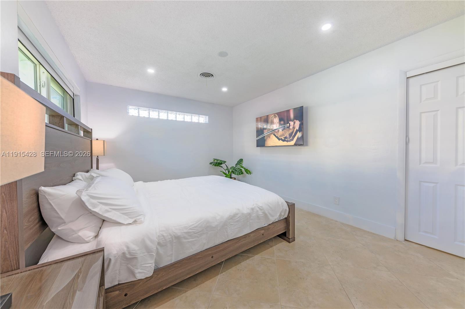 314 Southeast 3rd Street Dania Beach, FL 33004 - Photo 23 of 26 a bedroom with a bed and a painting on the wall