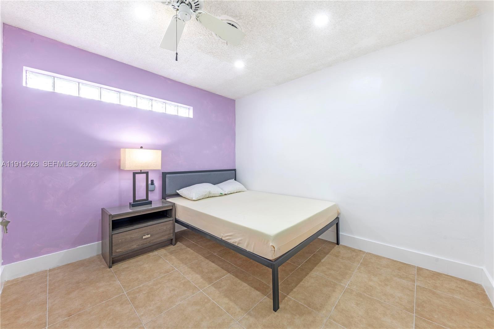 314 Southeast 3rd Street Dania Beach, FL 33004 - Photo 24 of 26 a spacious bedroom with a bed and a table