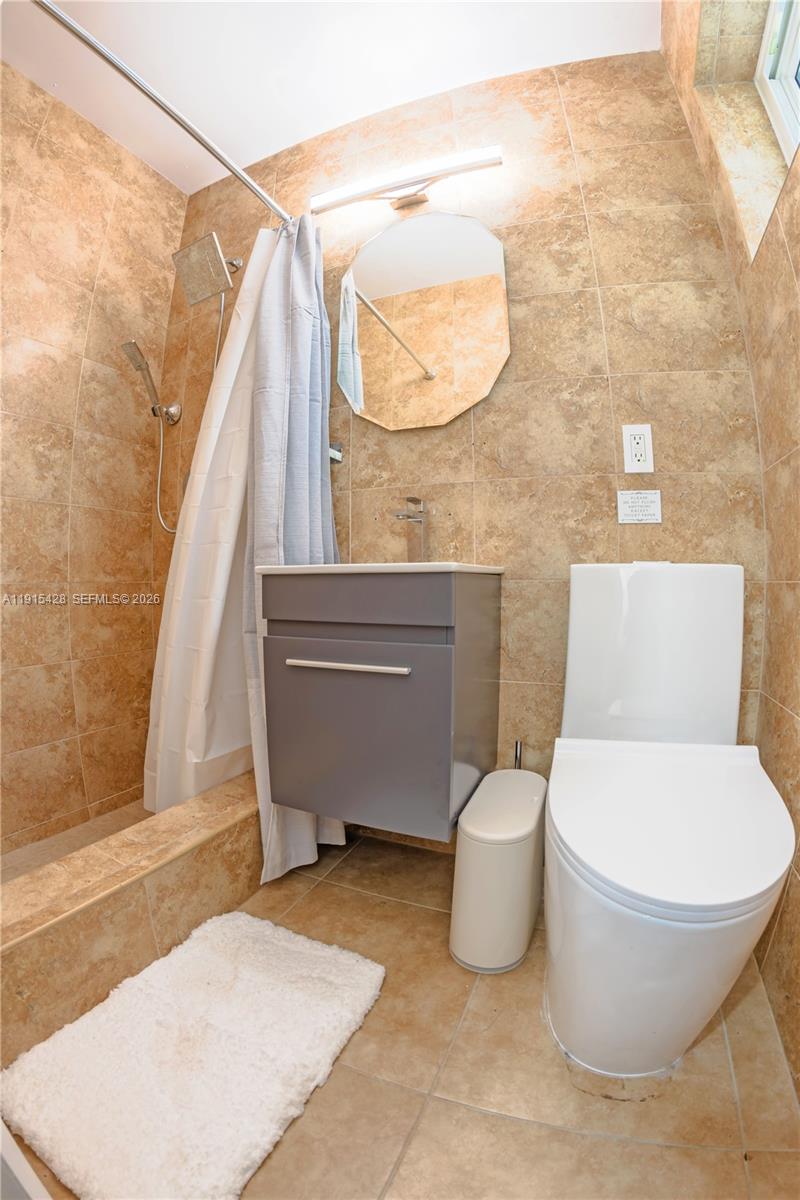 314 Southeast 3rd Street Dania Beach, FL 33004 - Photo 25 of 26 a white toilet sitting next to a bathroom sink