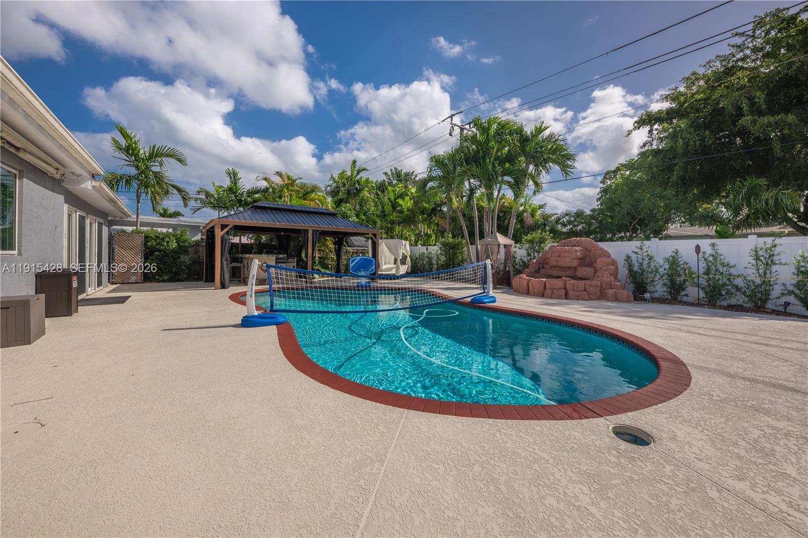 314 Southeast 3rd Street Dania Beach, FL 33004 - Photo 3 of 26 a view of a swimming pool with a patio