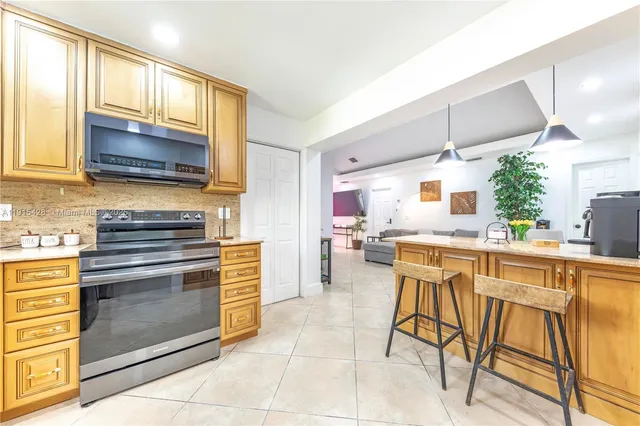 a kitchen with a stove a sink and a microwave