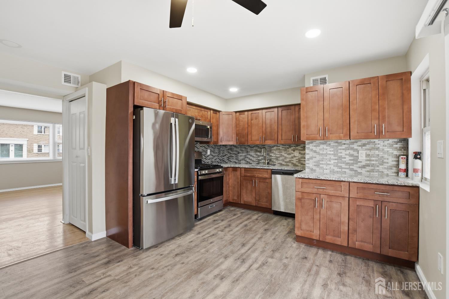 160 Evergreen Road, Unit 14A Edison, NJ 08837 - Photo 12 of 15 a kitchen with stainless steel appliances granite countertop a refrigerator and a sink