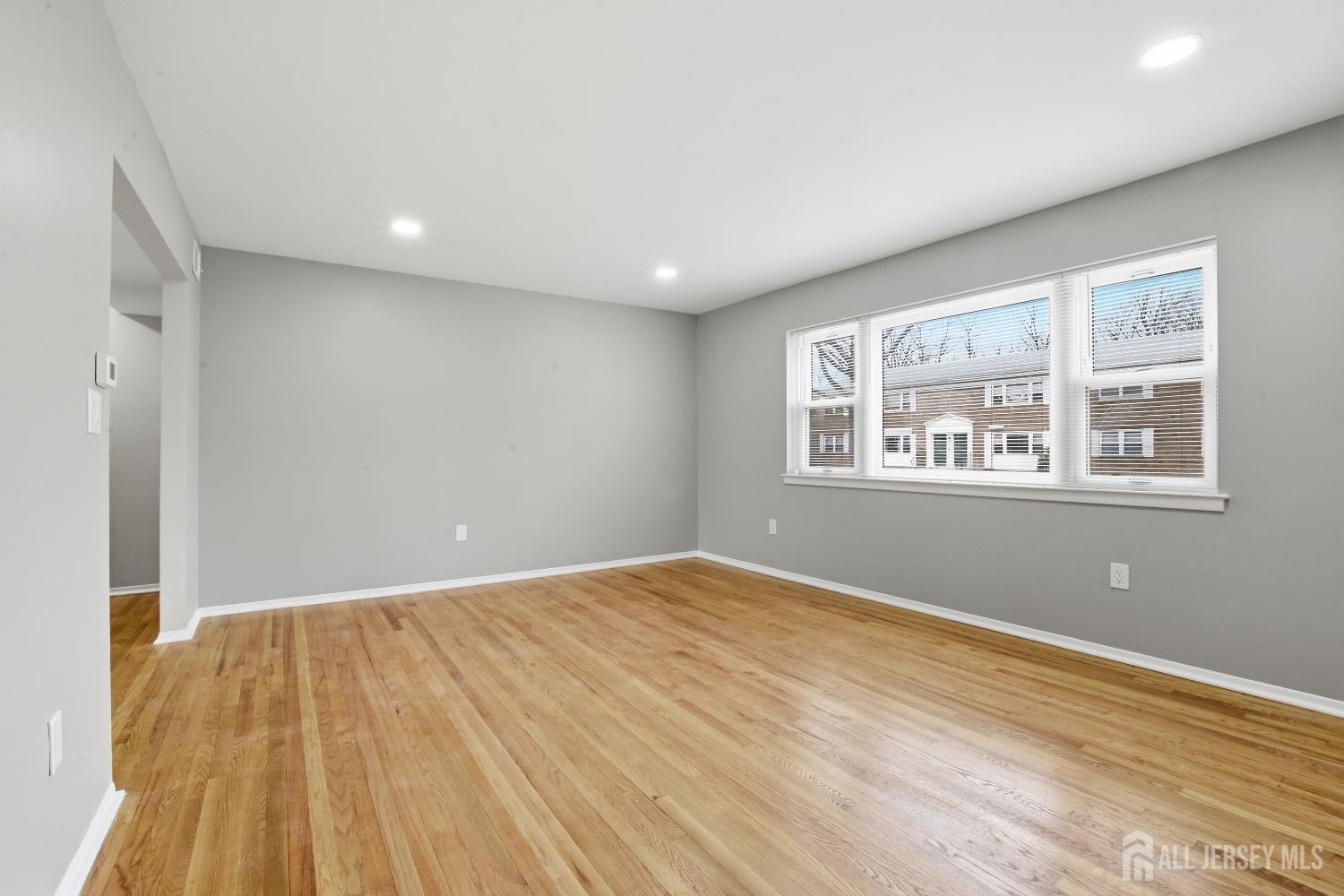 160 Evergreen Road, Unit 14A Edison, NJ 08837 - Photo 7 of 15 a view of empty room with wooden floor and fan