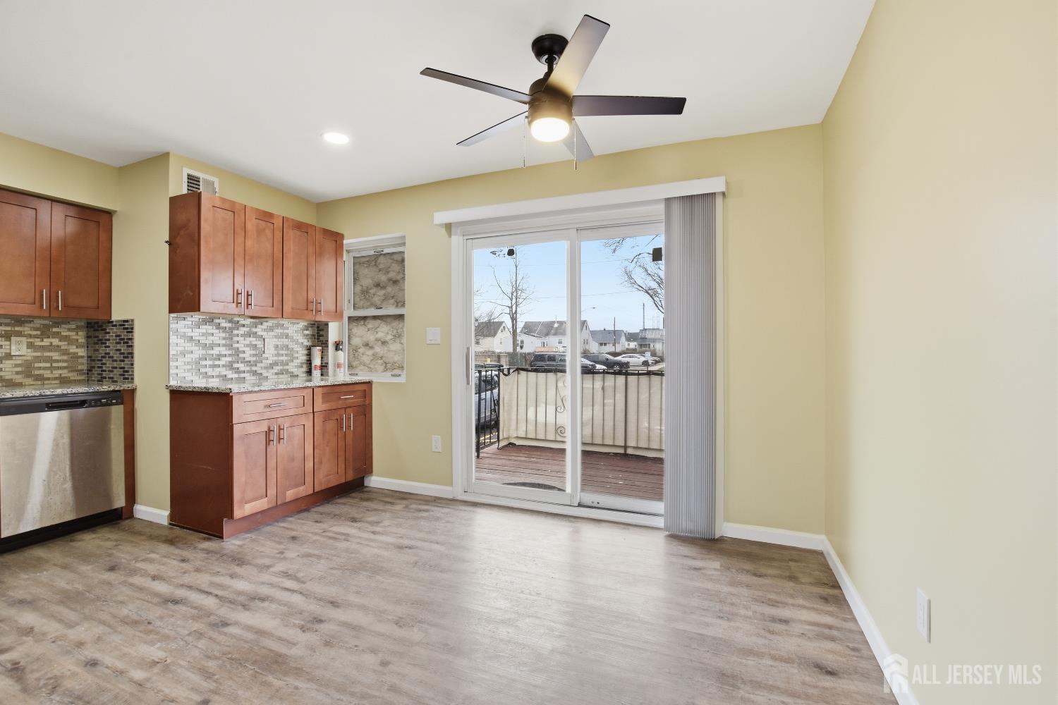 160 Evergreen Road, Unit 14A Edison, NJ 08837 - Photo 10 of 15 a kitchen with stainless steel appliances granite countertop a stove a refrigerator and a cabinets with wooden floor