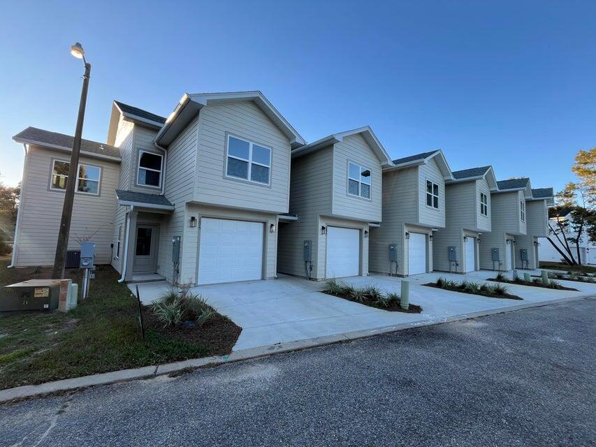 2879 Leahs Lane Navarre, FL 32566 - Photo 1 of 13 a front view of a house with a yard