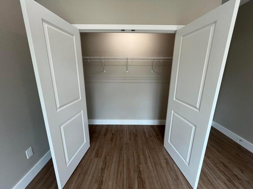 2879 Leahs Lane Navarre, FL 32566 - Photo 11 of 13 a view of walk in closet with wooden floor