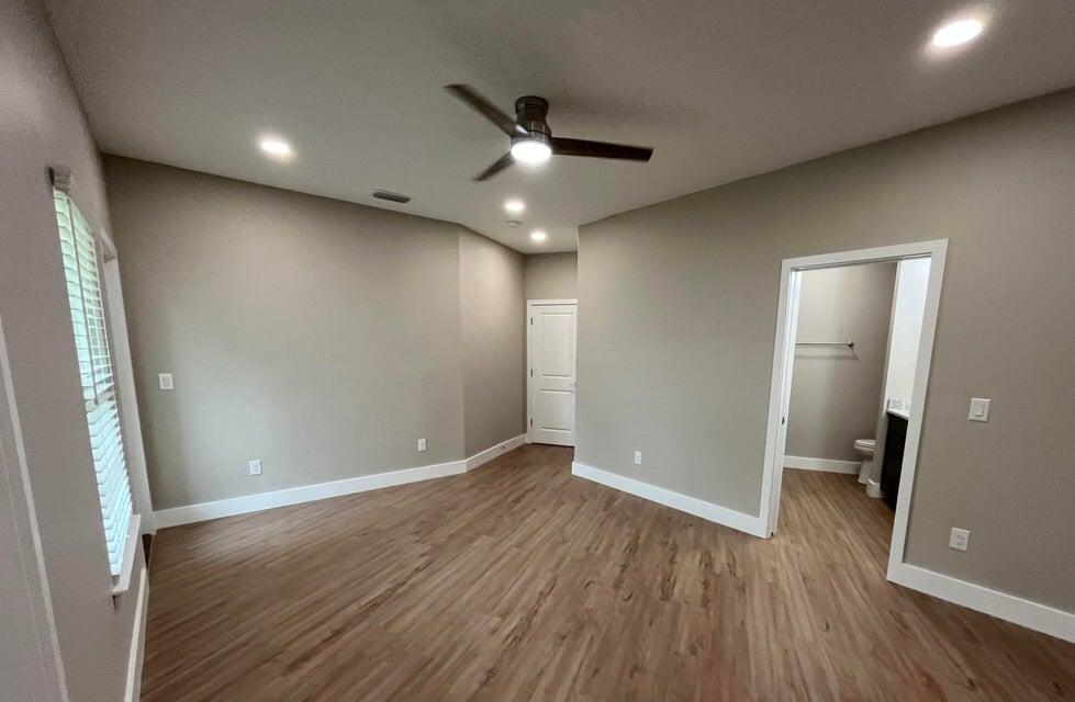 2879 Leahs Lane Navarre, FL 32566 - Photo 2 of 13 an empty room with wooden floor and a ceiling fan
