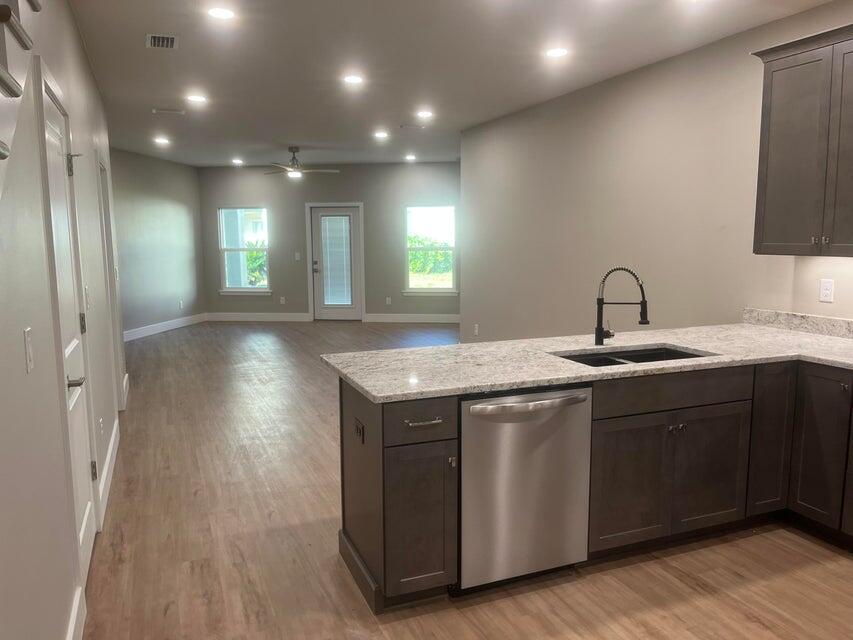 2879 Leahs Lane Navarre, FL 32566 - Photo 3 of 13 a kitchen with a sink and wooden floor