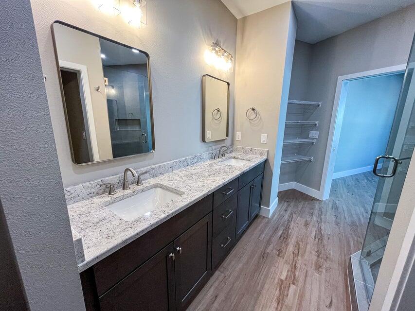 2879 Leahs Lane Navarre, FL 32566 - Photo 6 of 13 a bathroom with a granite countertop double vanity sink and mirror