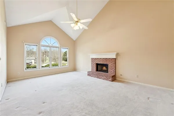 an empty room with furniture and a fireplace
