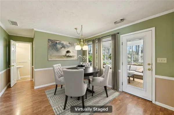 a dining room with furniture a chandelier and wooden floor