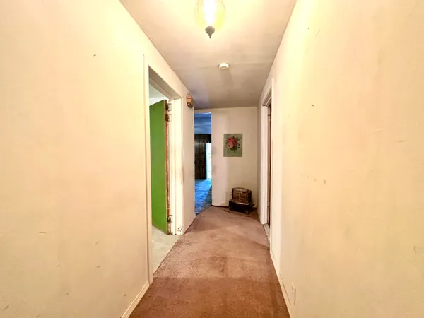 a view of a hallway with a living room