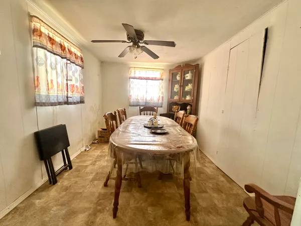 a view of a a dining room with furniture window and wooden floor