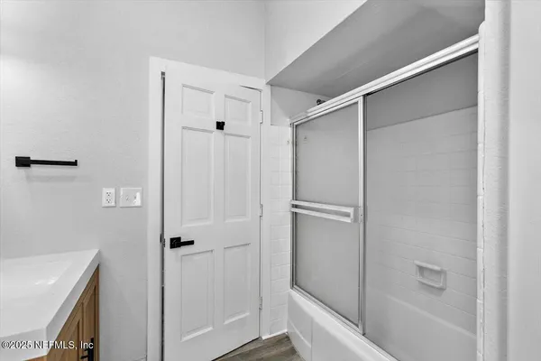 a bathroom with a shower and a tub