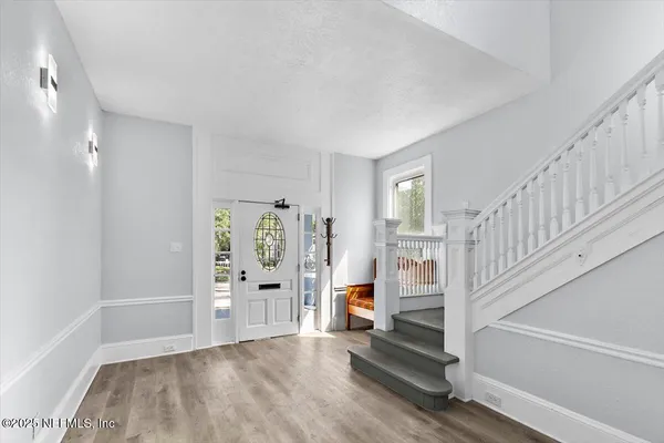 a view of an entryway with wooden floor