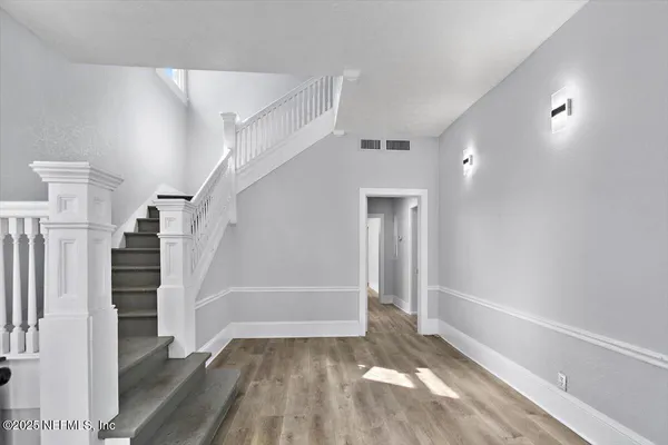 a view of entryway with wooden floor