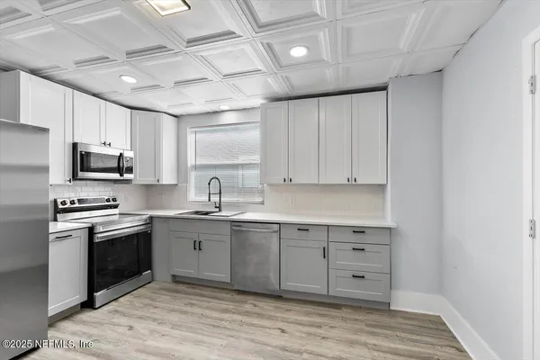 a kitchen with stainless steel appliances granite countertop a stove and a sink