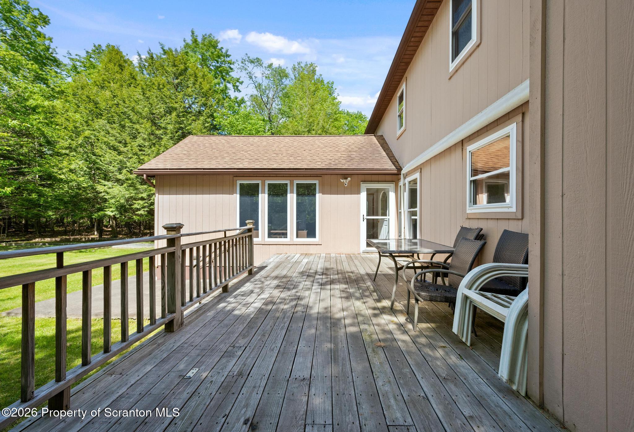 58 Bender Road Gouldsboro, PA 18424 - Photo 44 of 55 a view of a deck with chairs a barbeque with wooden floor and fence