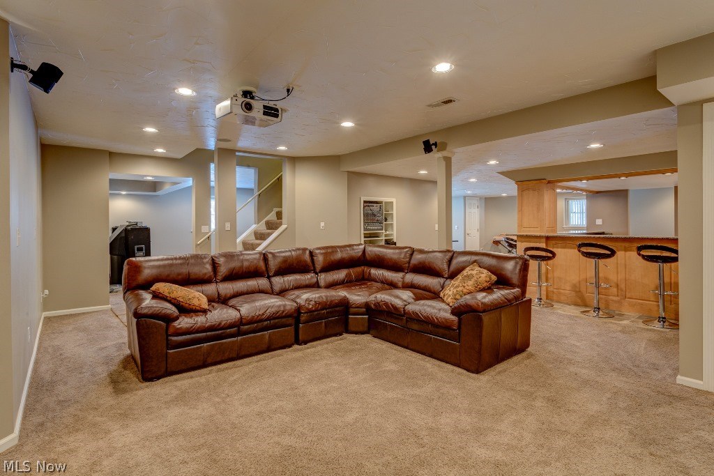 5571 High Point Road Solon, OH 44139 - Photo 26 of 34 The finished walkout lower level is great for entertaining with a home theater, rec room, custom wine bar with granite, an exercise area and newer full bath