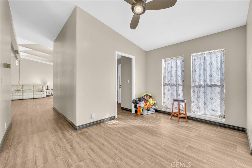 21720 Yucca Road Perris, CA 92570 - Photo 11 of 58 a view of room with wooden floor and windows