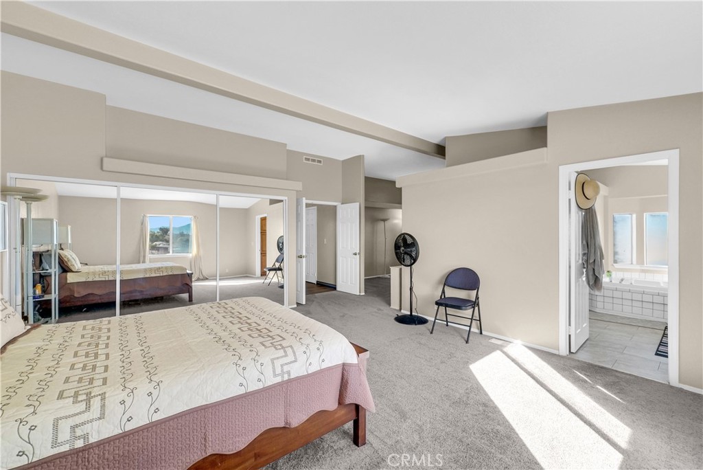 21720 Yucca Road Perris, CA 92570 - Photo 17 of 58 a bedroom with a bed and a dresser next to a window