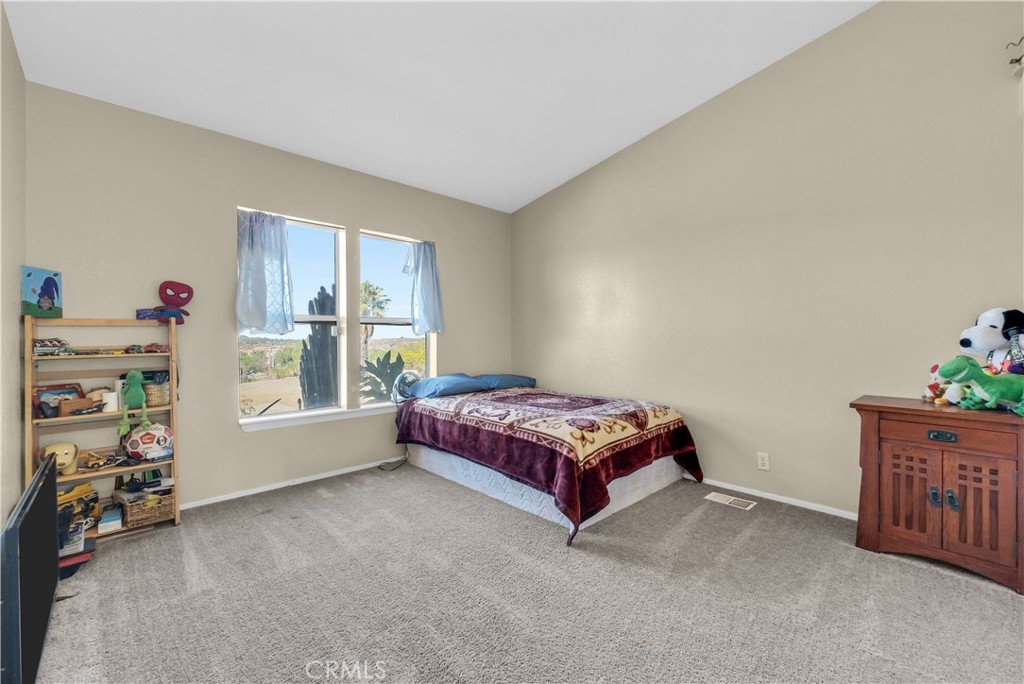 21720 Yucca Road Perris, CA 92570 - Photo 21 of 58 a bedroom with a bed and a window