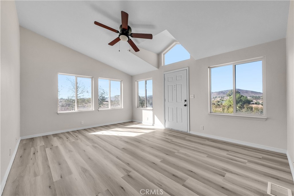 21720 Yucca Road Perris, CA 92570 - Photo 29 of 58 a view of an empty room with a window and wooden floor