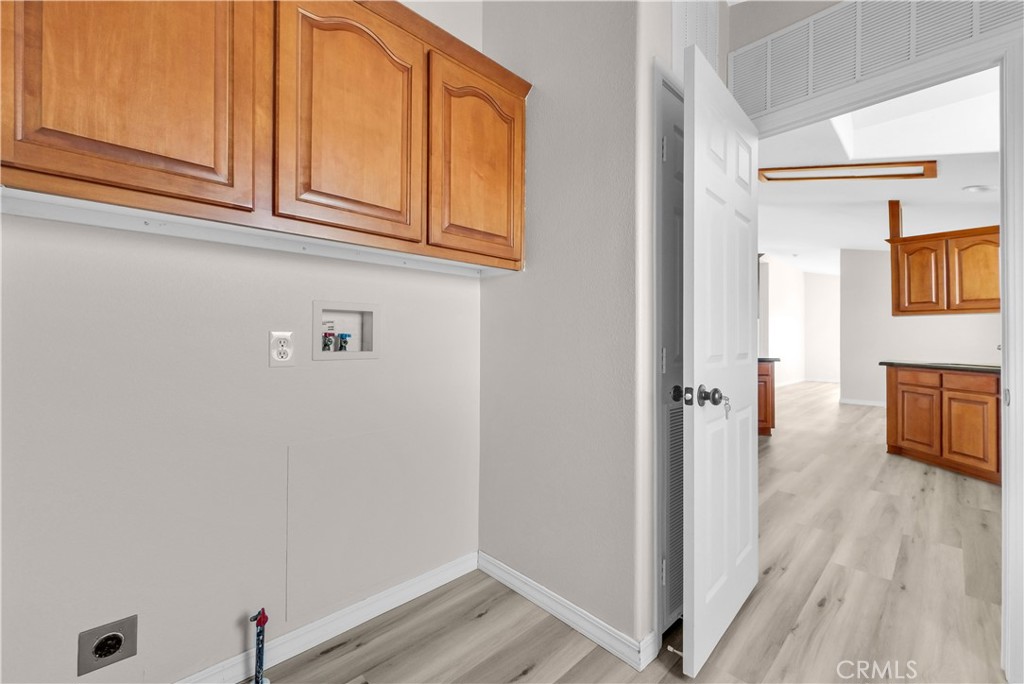 21720 Yucca Road Perris, CA 92570 - Photo 37 of 58 a view of a hallway with wooden floor and cabinet