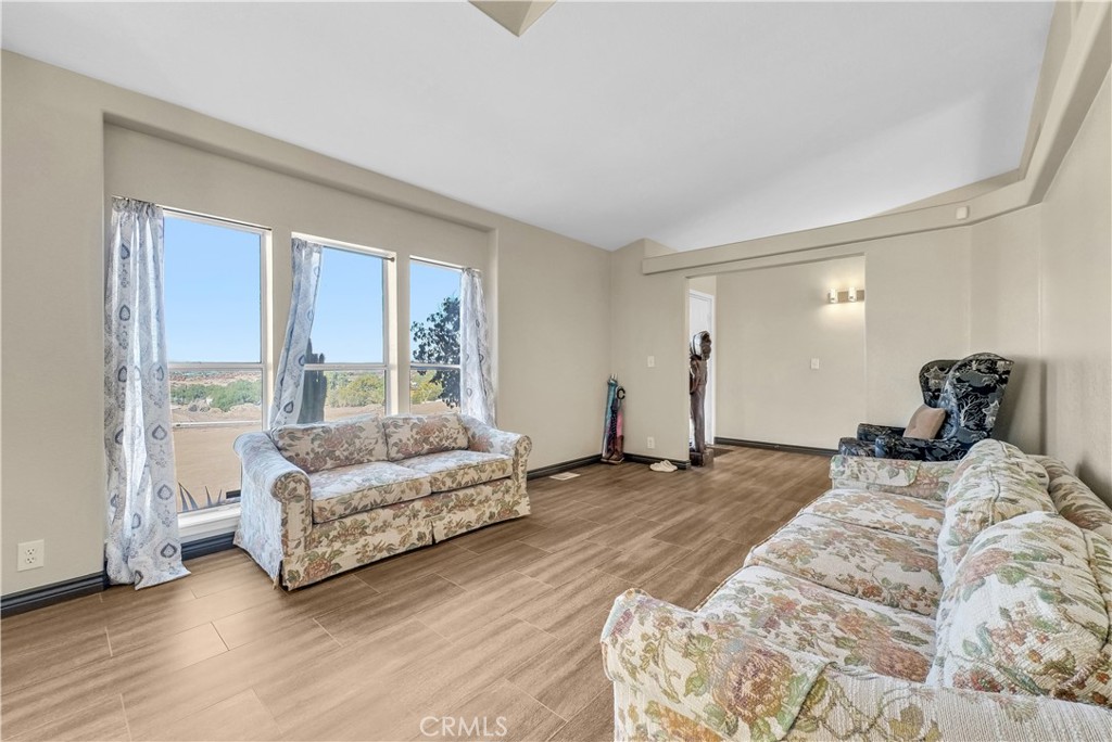 21720 Yucca Road Perris, CA 92570 - Photo 6 of 58 a bed room with a bed and a couch