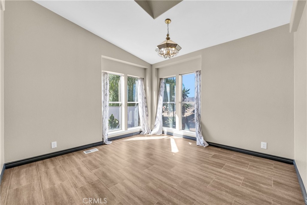 21720 Yucca Road Perris, CA 92570 - Photo 7 of 58 wooden floor in an empty room with a window