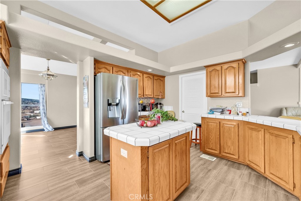 21720 Yucca Road Perris, CA 92570 - Photo 9 of 58 a kitchen with stainless steel appliances granite countertop a sink stove and refrigerator