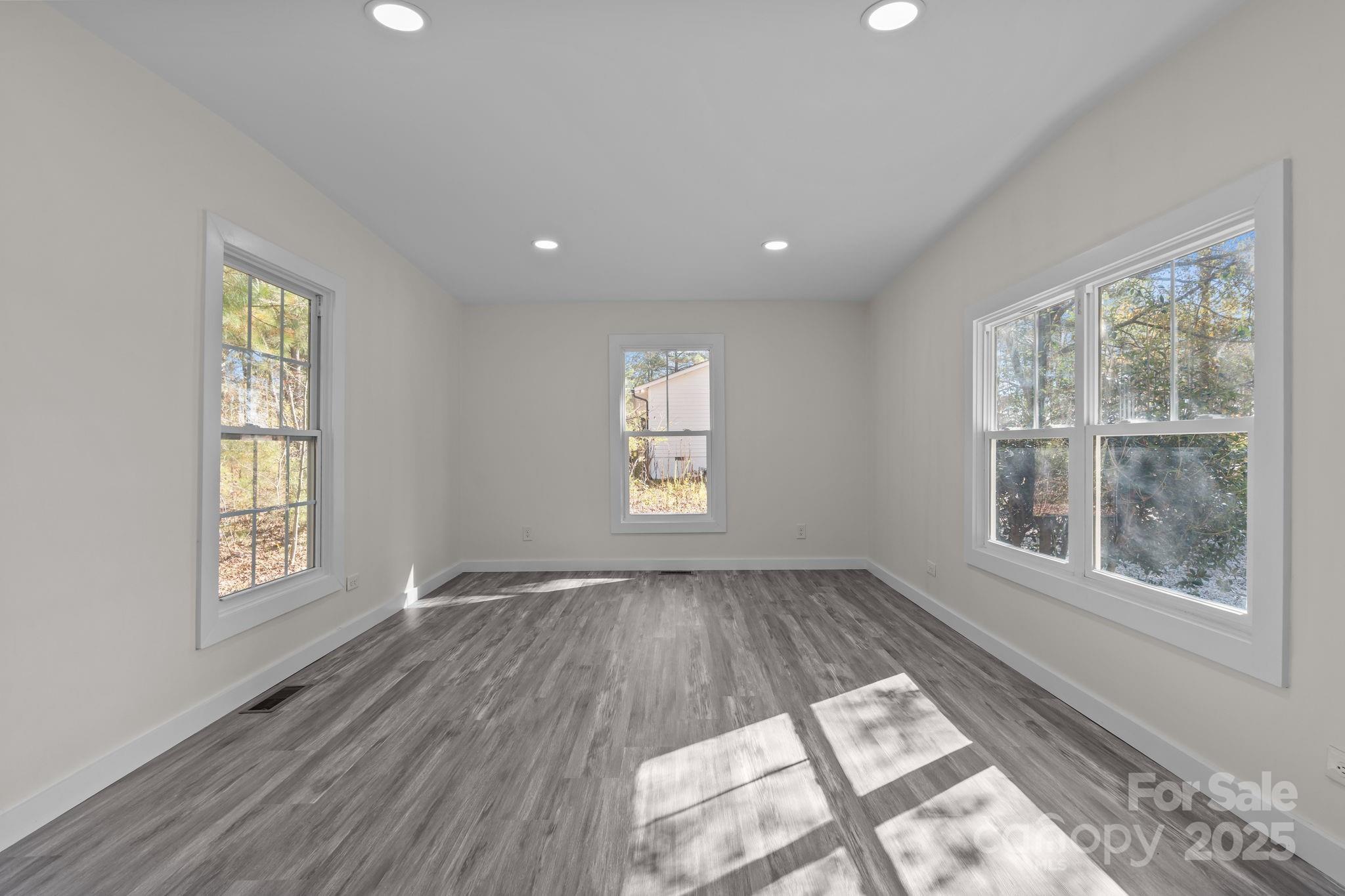2627 McCallum Road Candor, NC 27229 - Photo 11 of 41 an empty room with wooden floor and windows