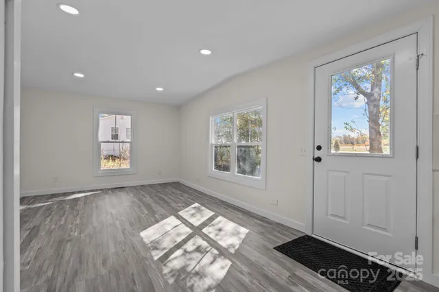 a view of wooden floor and windows in a room
