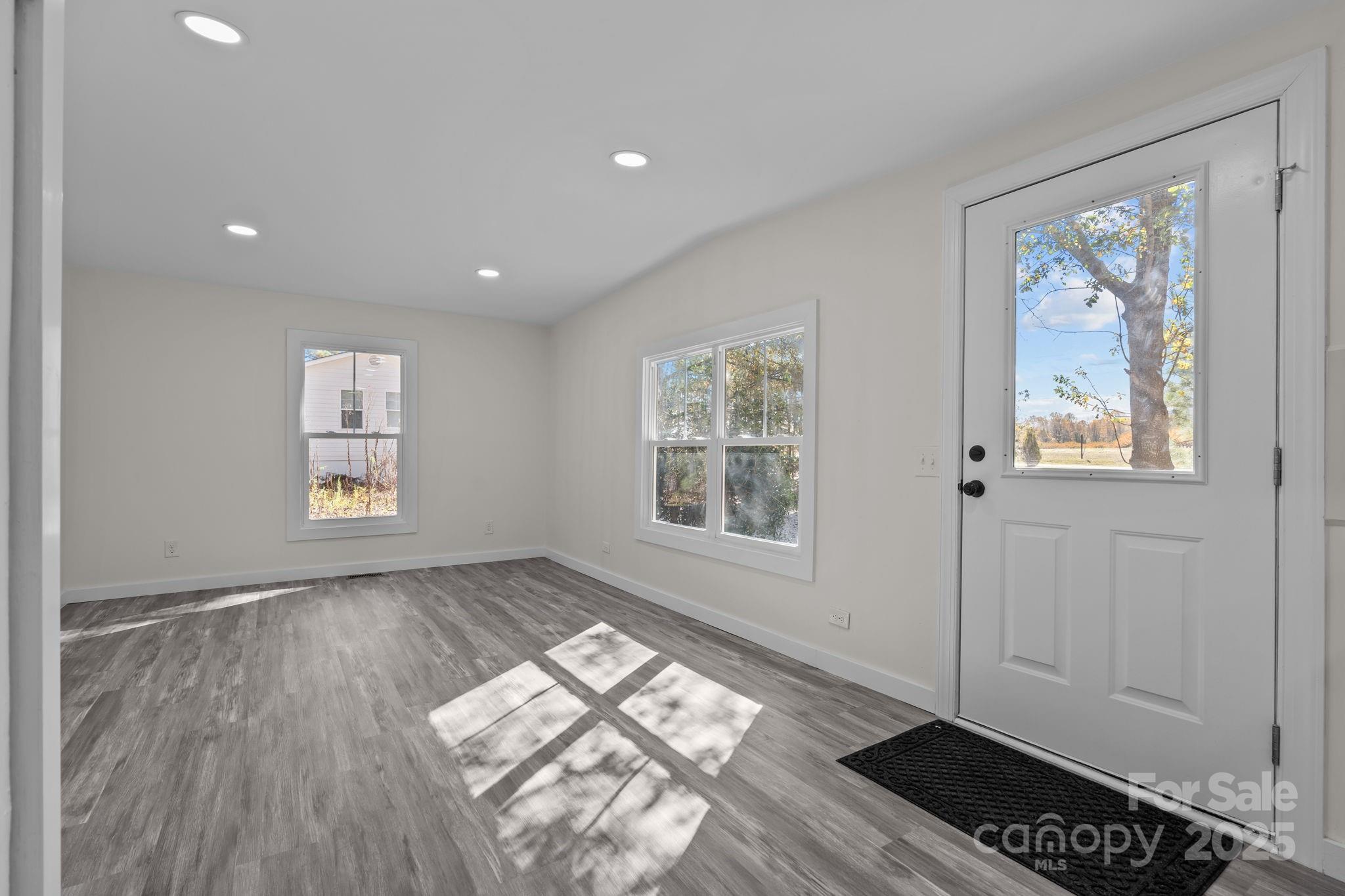 2627 McCallum Road Candor, NC 27229 - Photo 12 of 41 a view of wooden floor and windows in a room