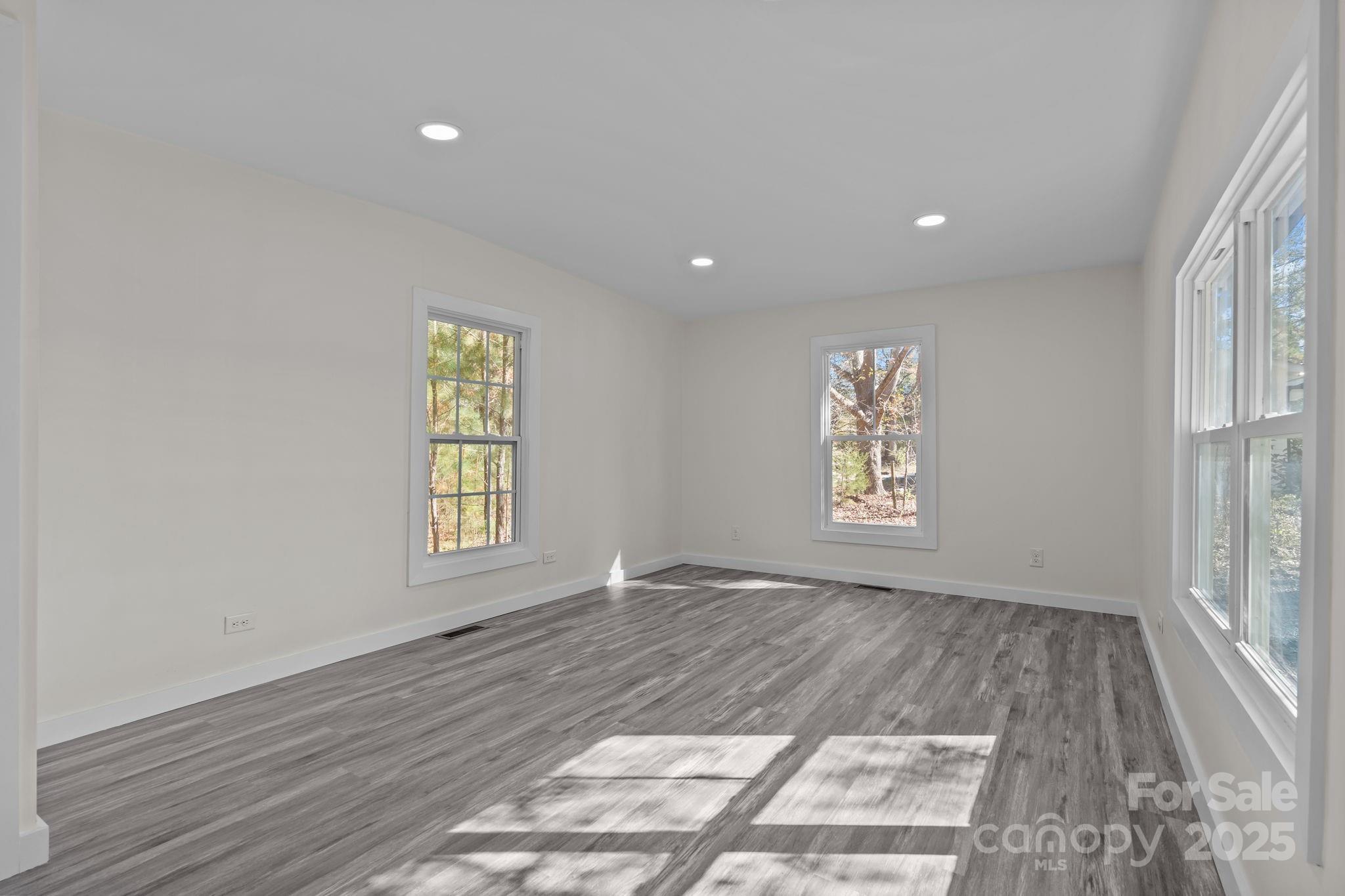 2627 McCallum Road Candor, NC 27229 - Photo 13 of 41 an empty room with wooden floor and windows