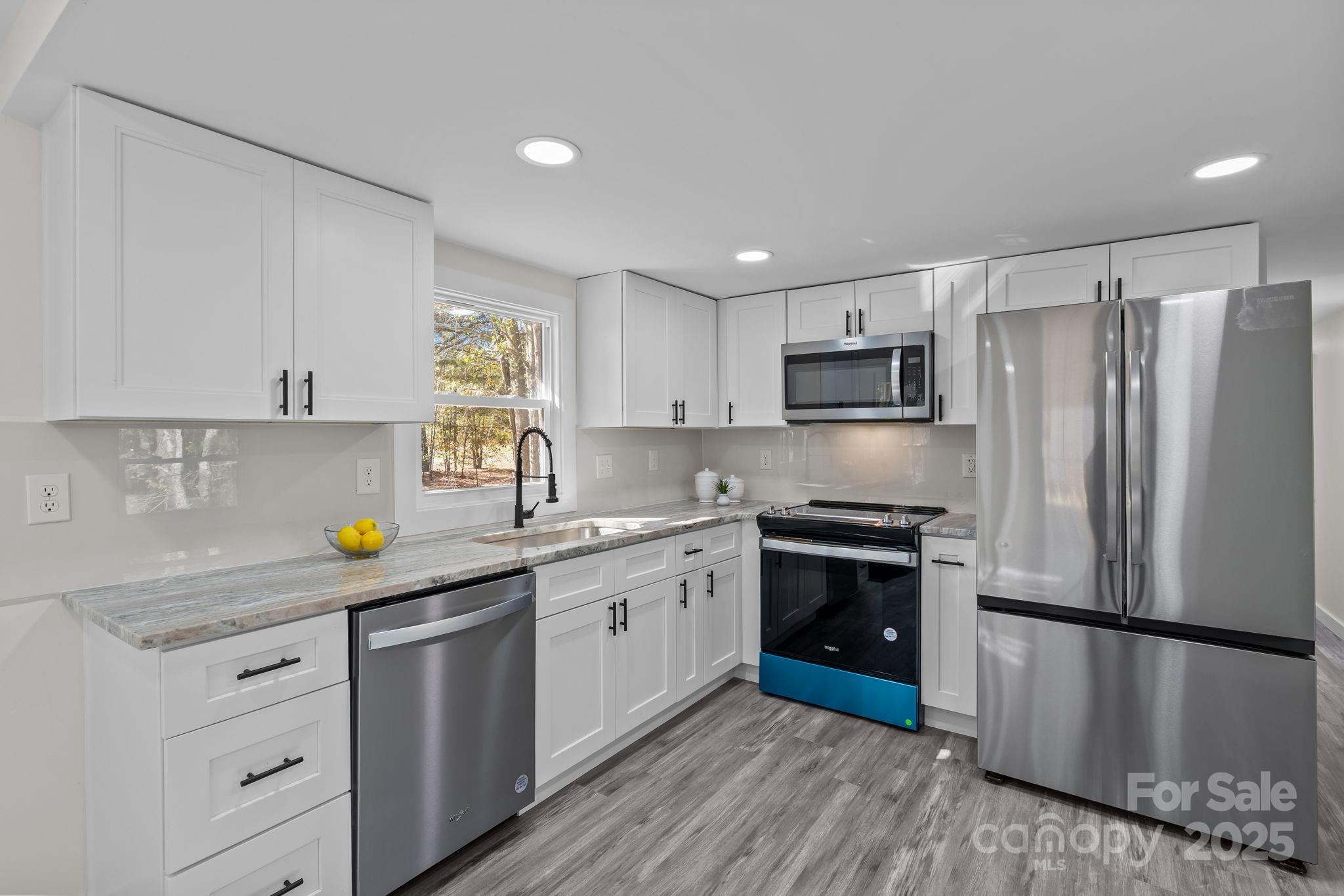 2627 McCallum Road Candor, NC 27229 - Photo 15 of 41 a kitchen with stainless steel appliances a refrigerator sink and microwave