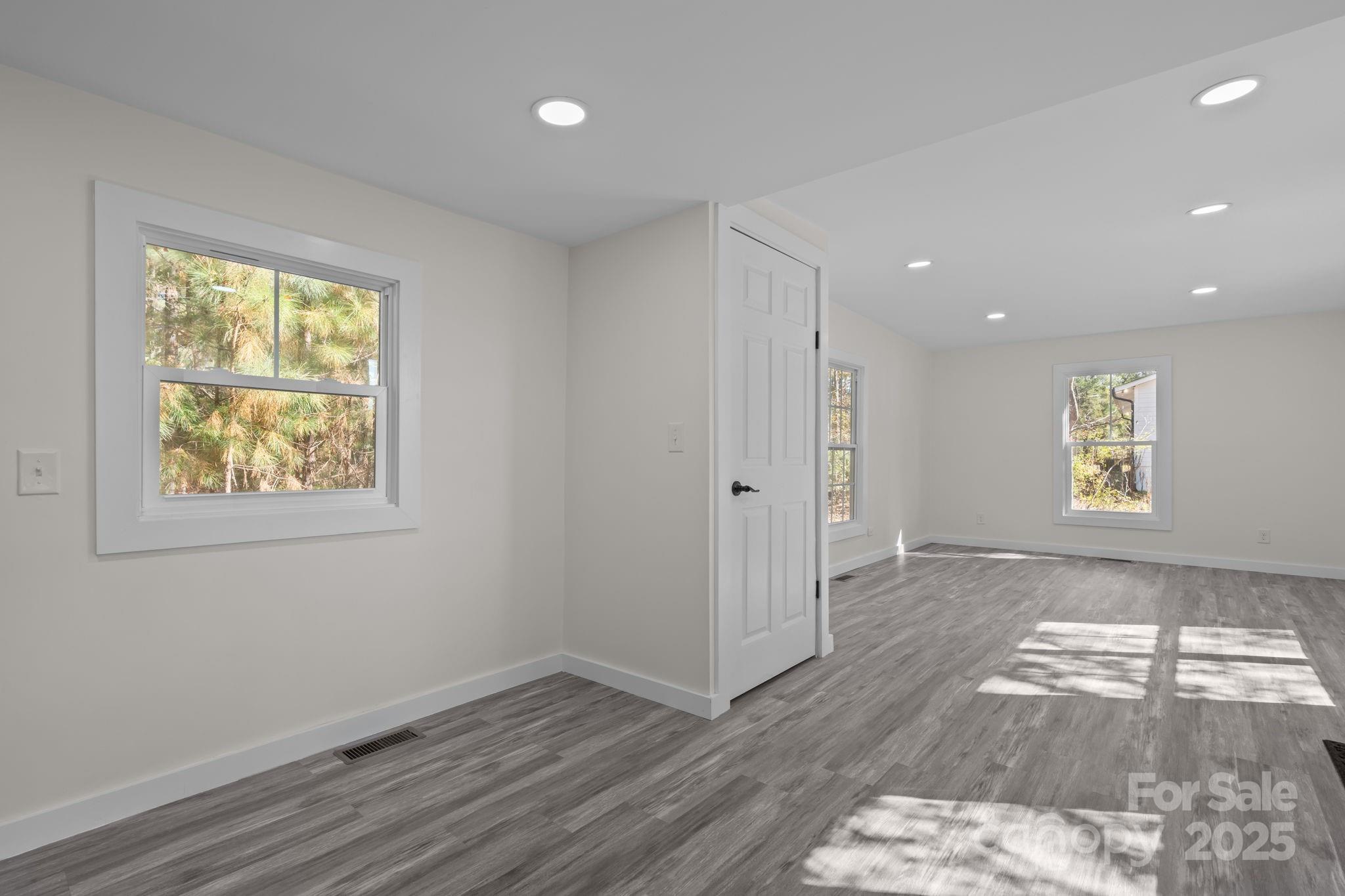 2627 McCallum Road Candor, NC 27229 - Photo 19 of 41 an empty room with wooden floor and windows