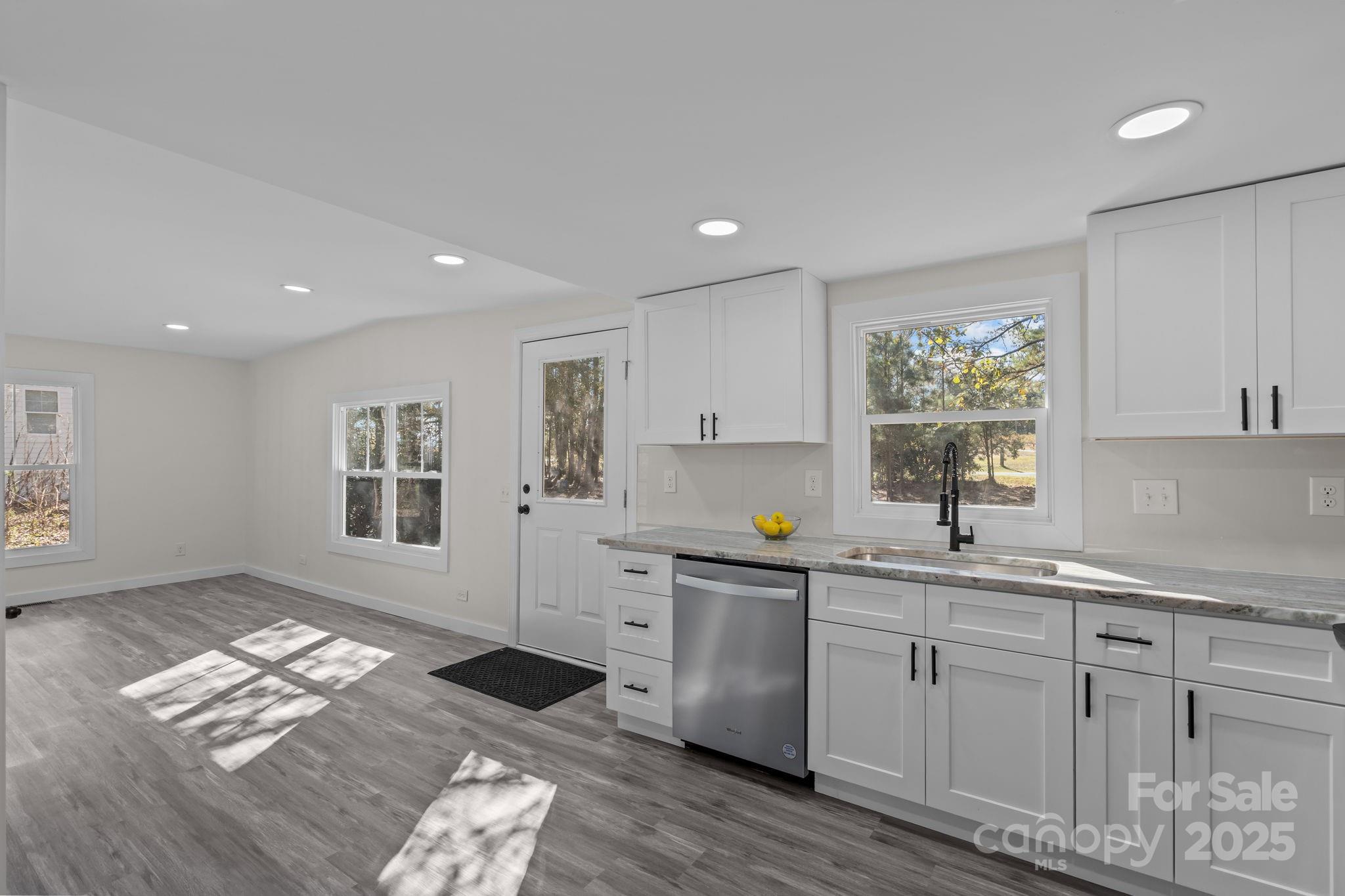 2627 McCallum Road Candor, NC 27229 - Photo 20 of 41 a open kitchen with granite countertop a sink window and cabinets