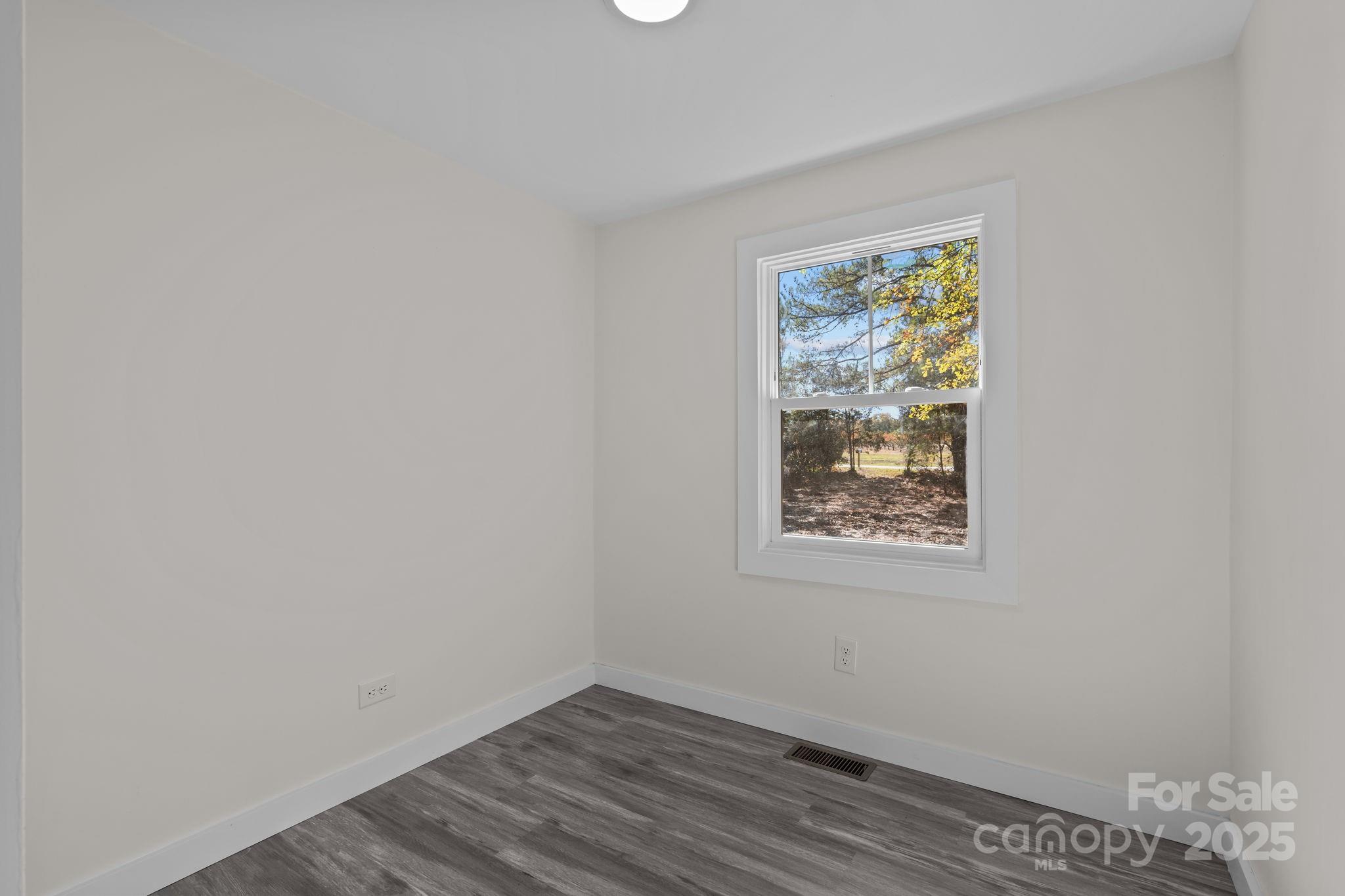 2627 McCallum Road Candor, NC 27229 - Photo 24 of 41 a view of a small space with wooden floor and a window