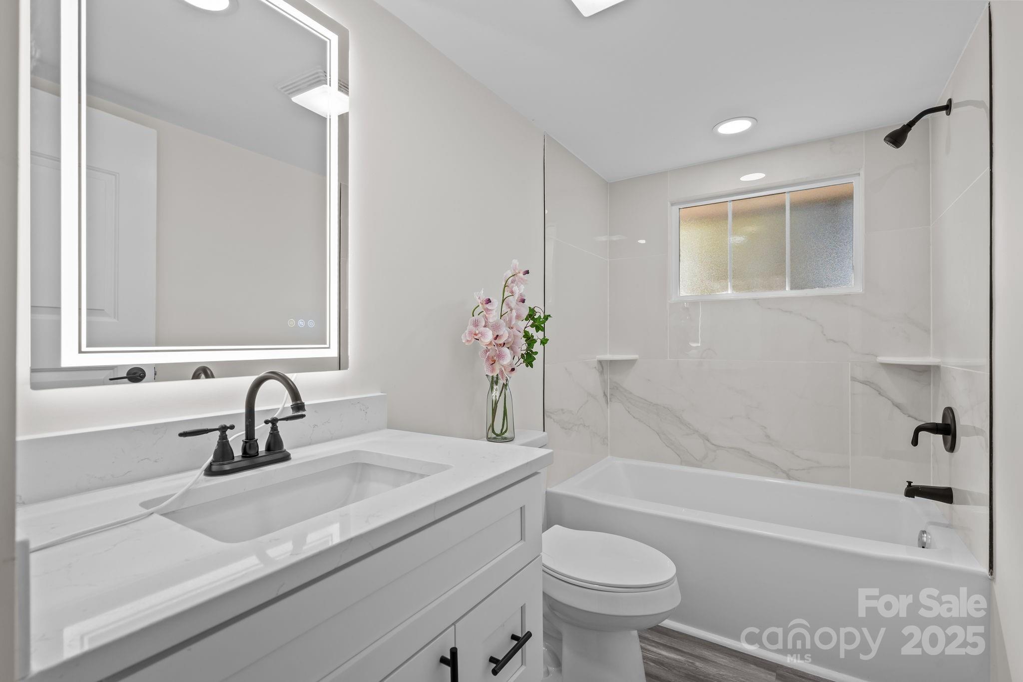 2627 McCallum Road Candor, NC 27229 - Photo 26 of 41 a bathroom with a sink a toilet and a bathtub