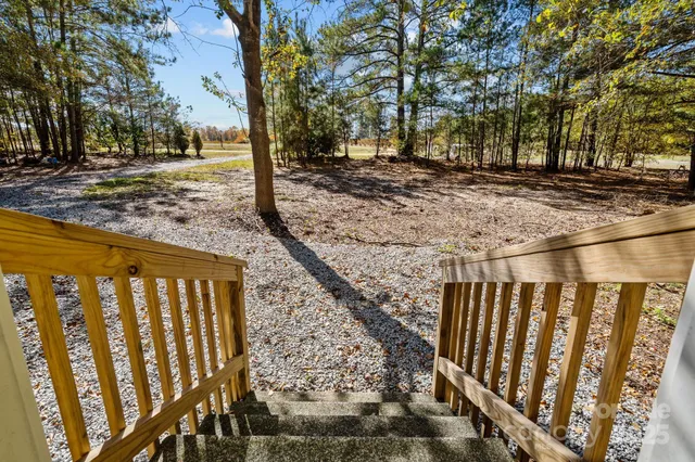 a view of a pathway of a yard with wooden fence