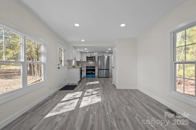 a view of wooden floor and windows in an empty room