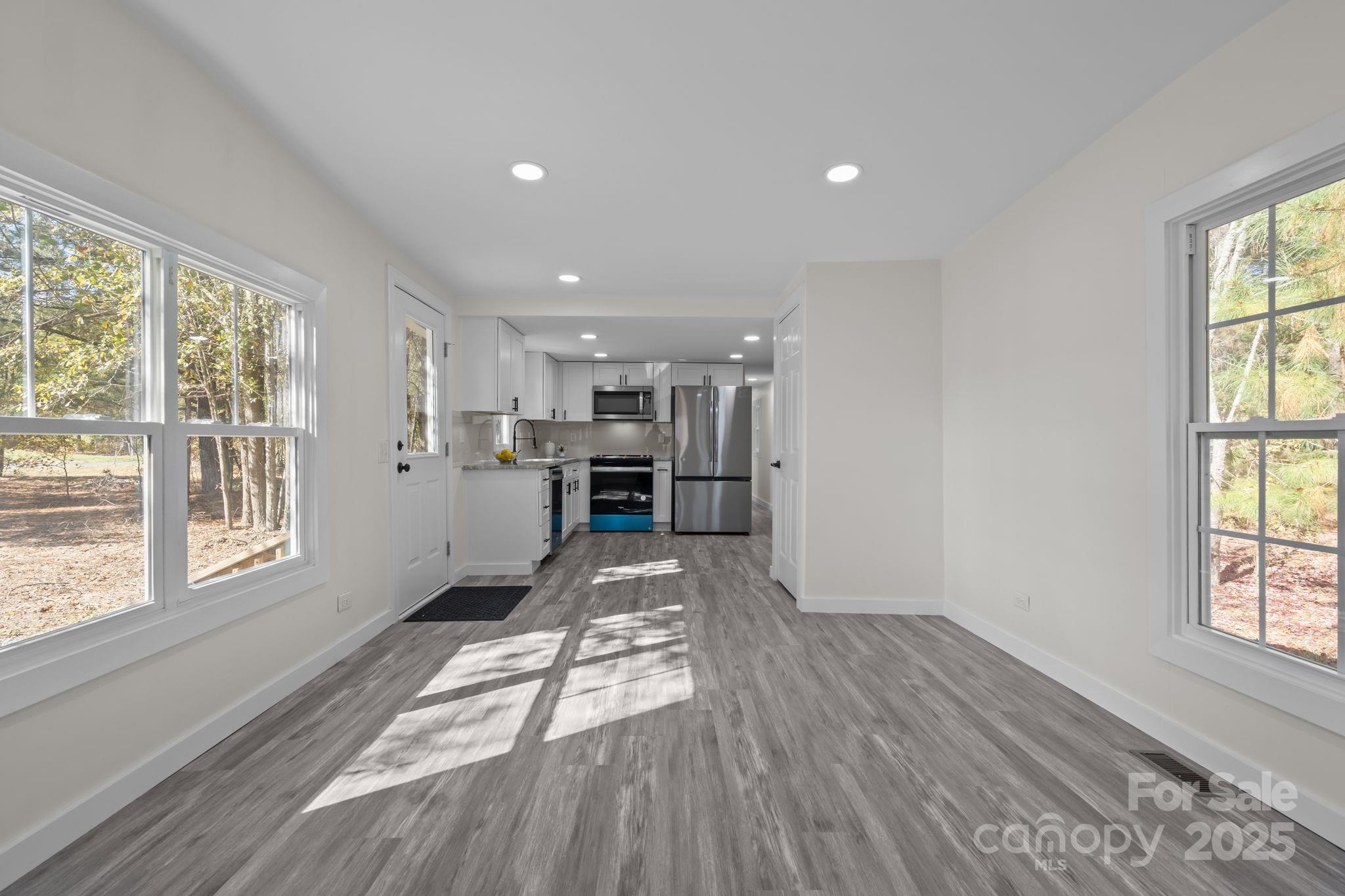 2627 McCallum Road Candor, NC 27229 - Photo 8 of 41 a view of wooden floor and windows in an empty room