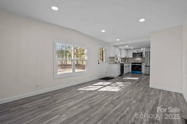 a view of kitchen and refrigerator