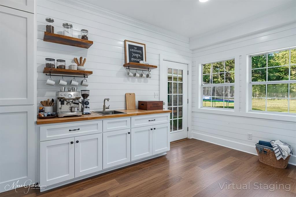 550 Linton Bellevue Road Benton, LA 71006 - Photo 32 of 37 Bar with wooden counters, white cabinets, open shelves, wooden walls, and dark wood finished floors