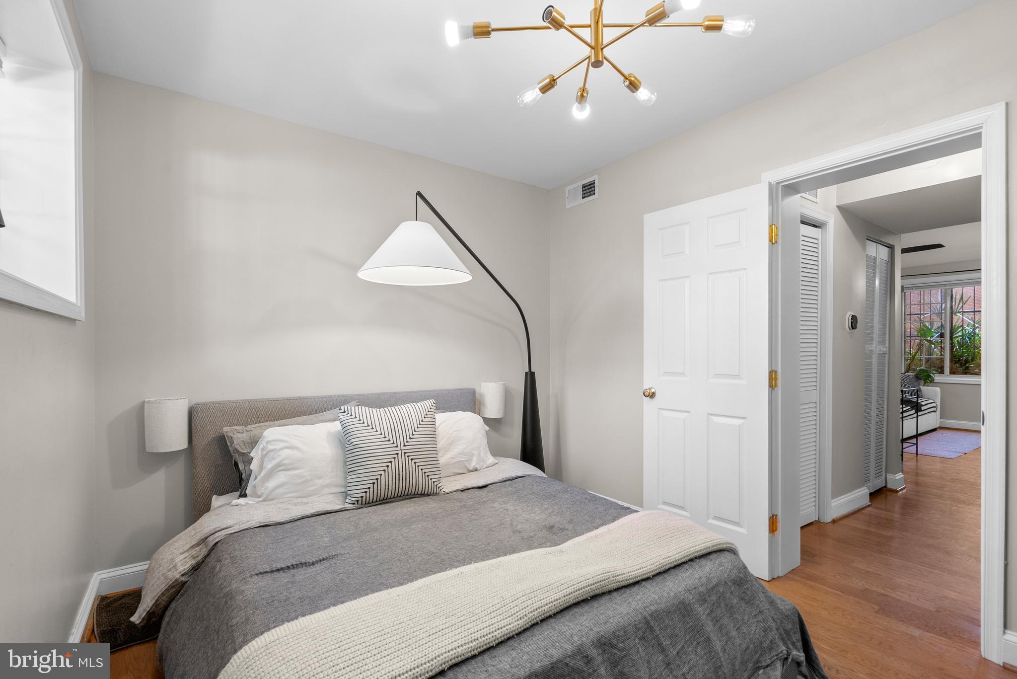 718 Park Road Northwest, Unit 1 Washington, DC 20010 - Photo 24 of 28 a bedroom with bed and wooden floor