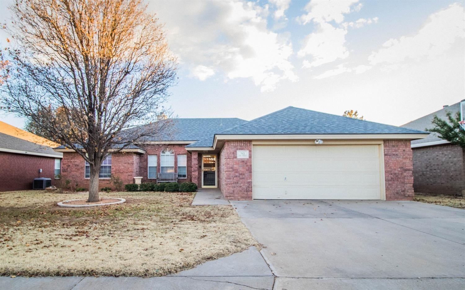 5821 89th Street Lubbock, TX 79424 - Photo 1 of 19 a front view of a house with a yard and garage