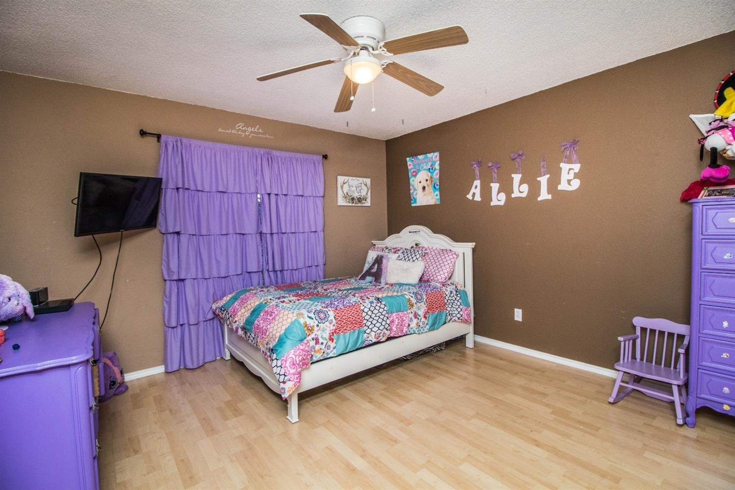 5821 89th Street Lubbock, TX 79424 - Photo 11 of 19 a bedroom with a bed and a tv in it