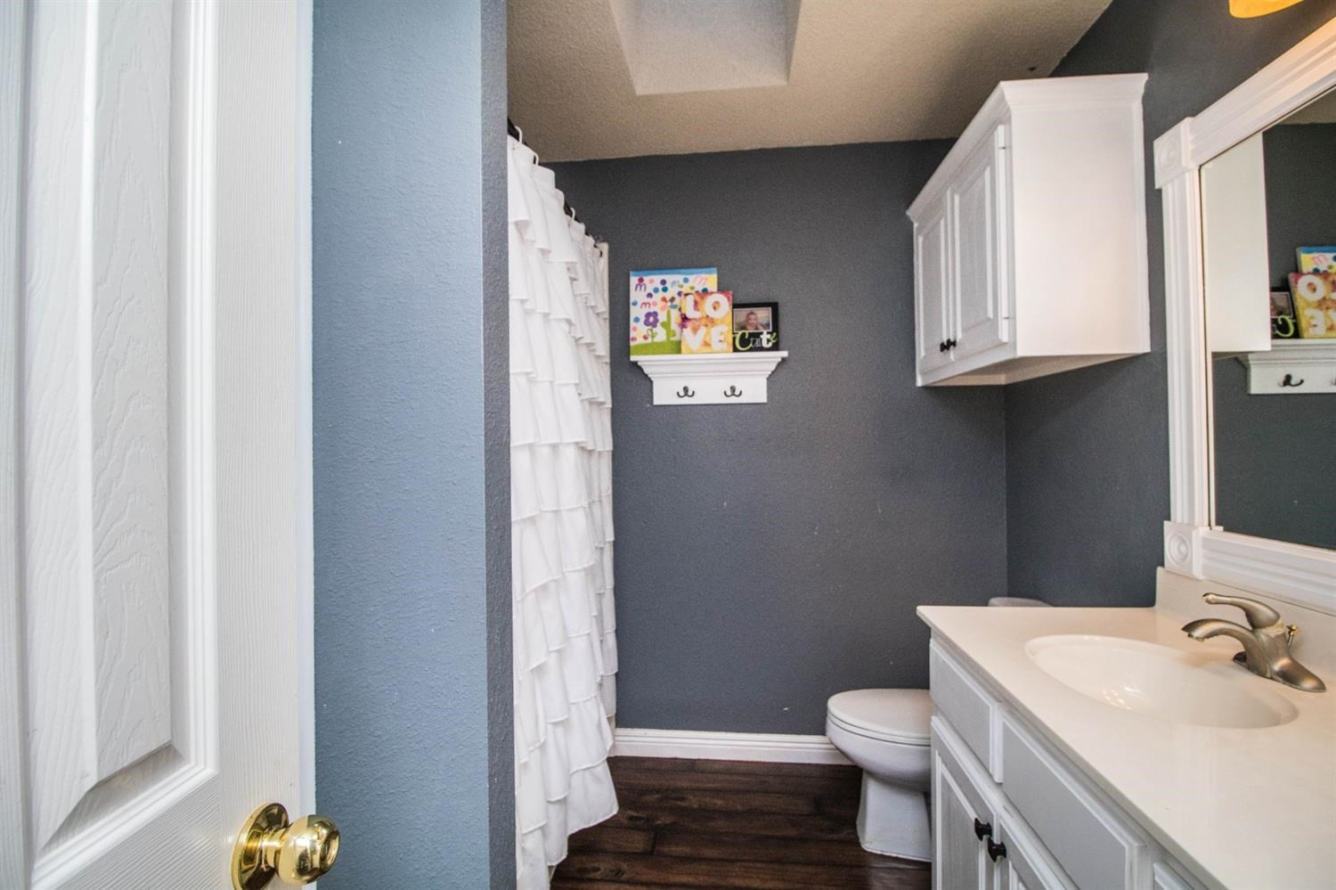 5821 89th Street Lubbock, TX 79424 - Photo 12 of 19 a bathroom with a sink a toilet and vanity